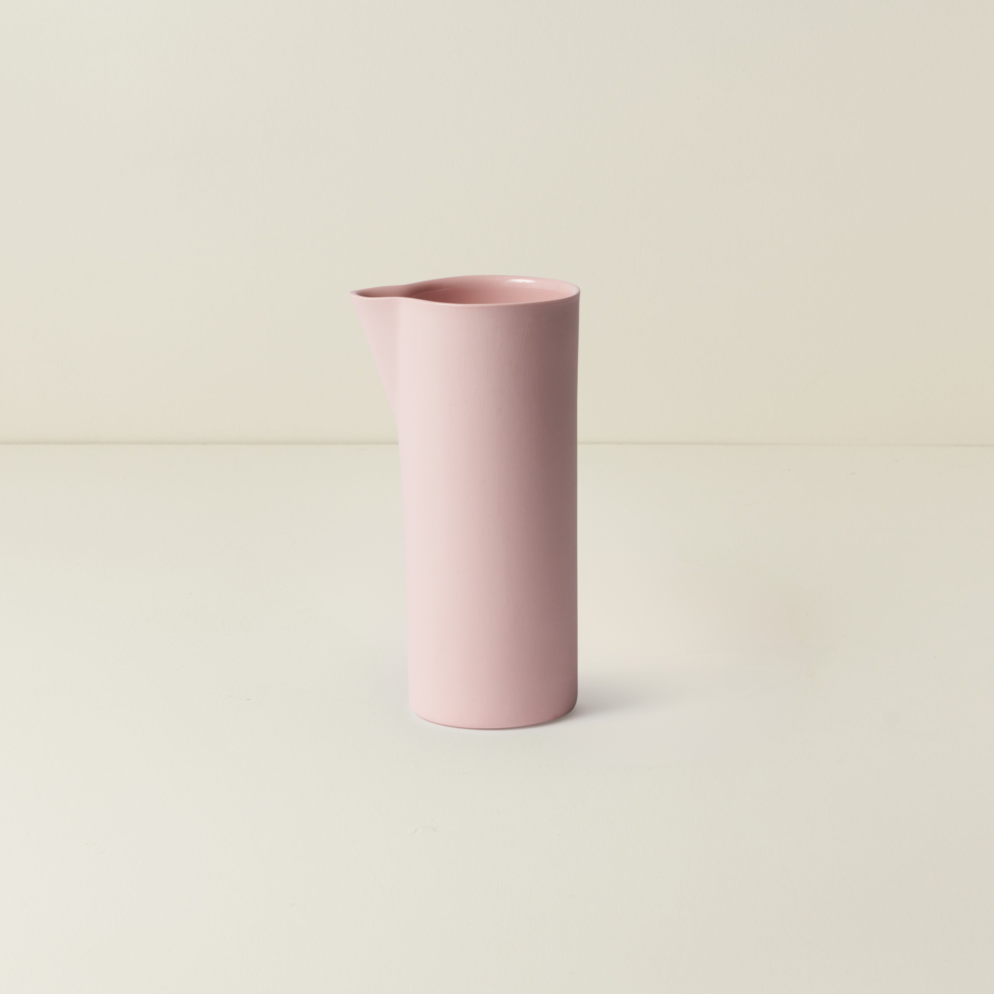 Pink cylindrical vase on a light beige background