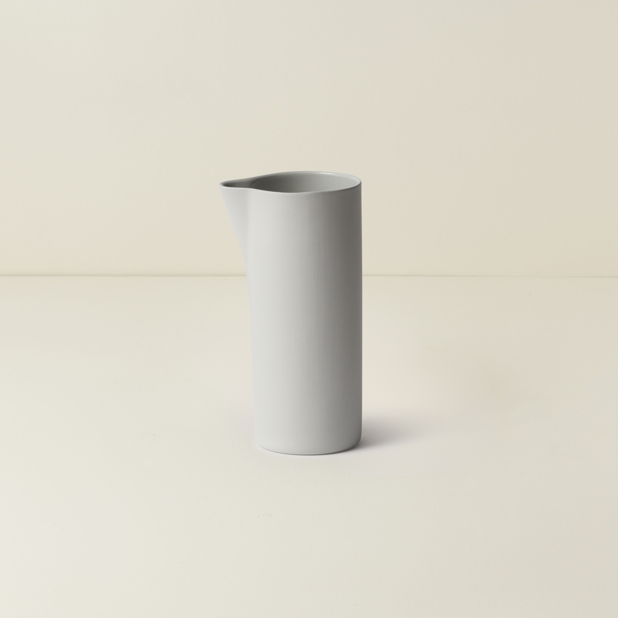 Gray ceramic vase on a beige background