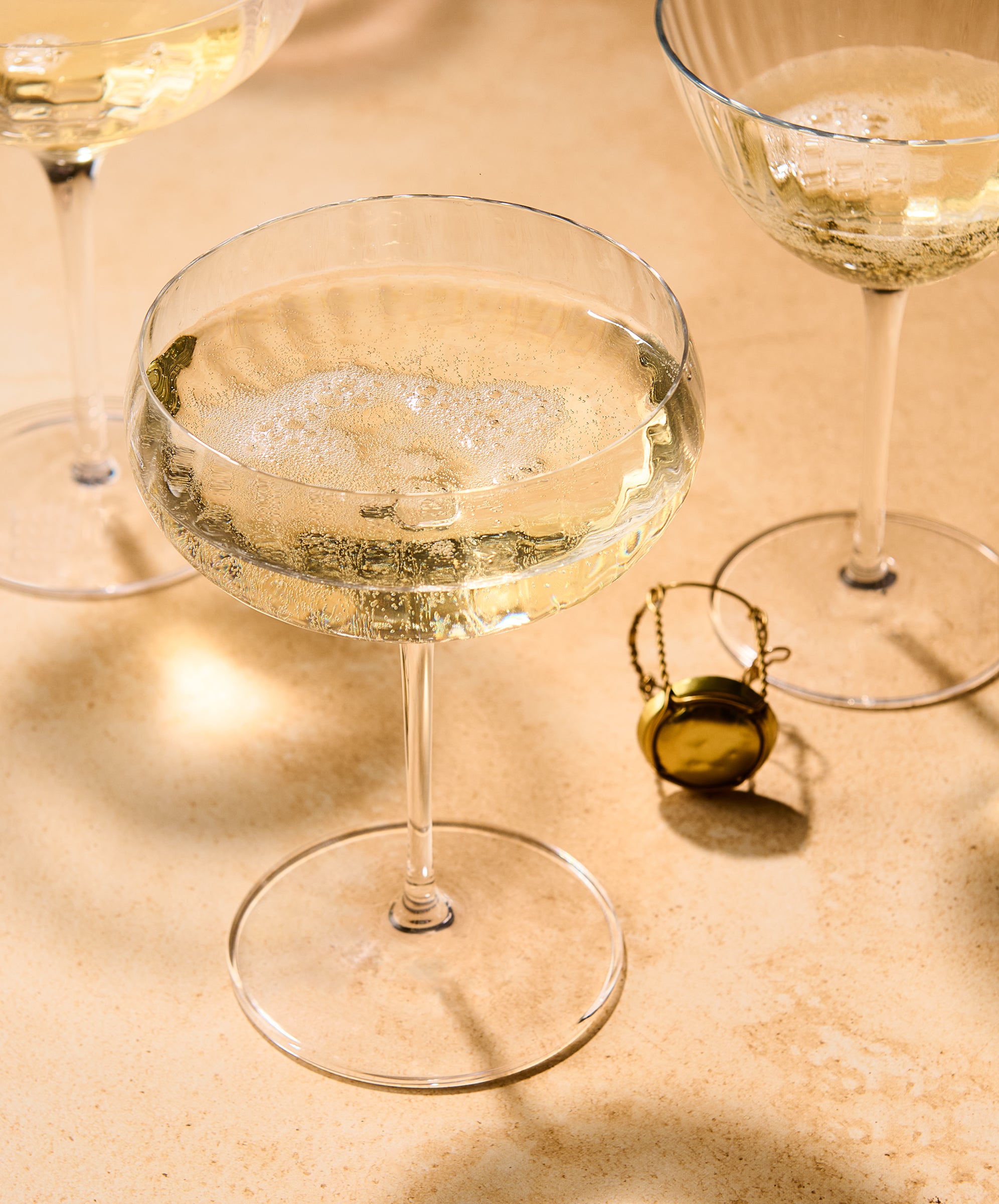 Cocktail glass with bubbly drink on a textured surface