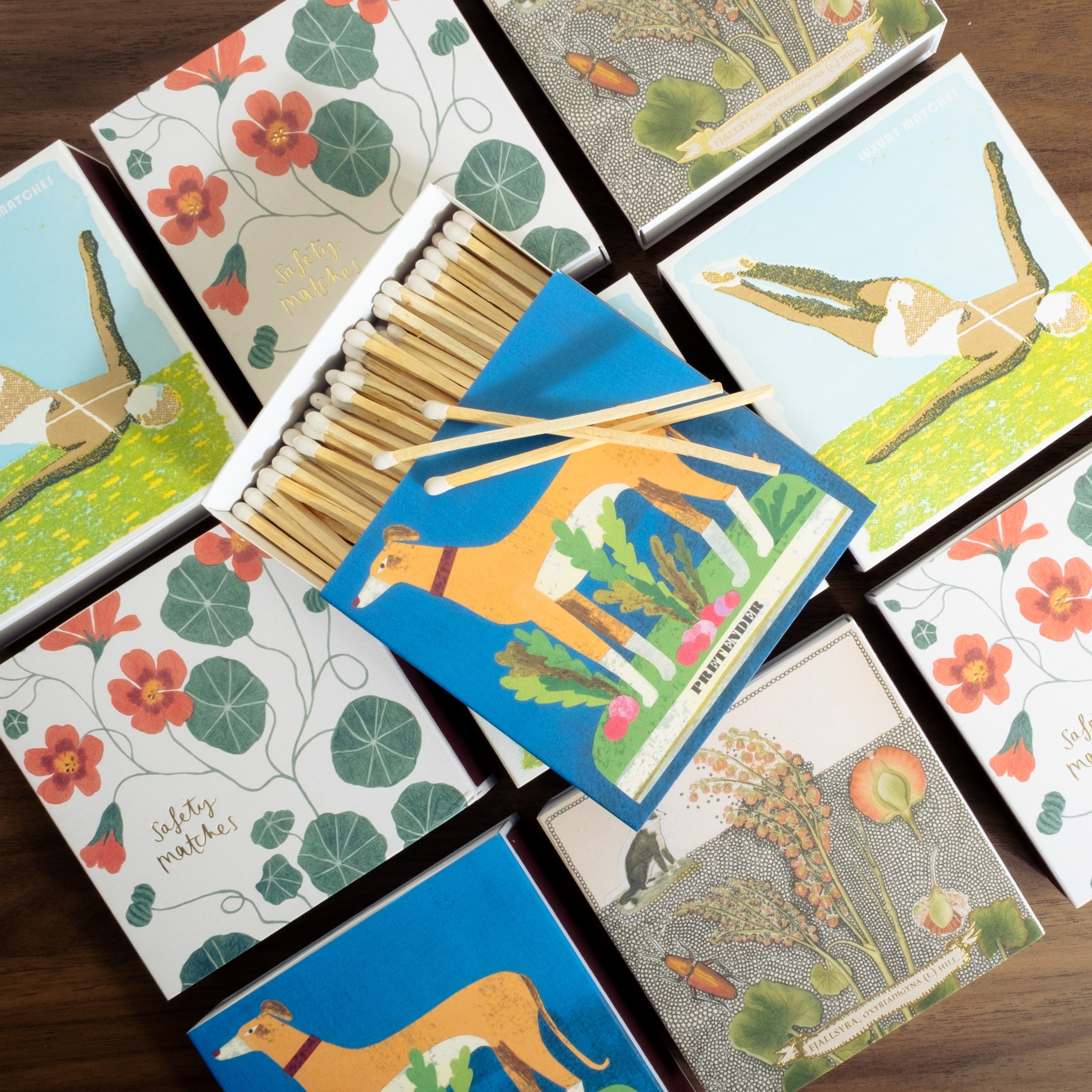 Set of matchboxes with animal illustrations on a wooden surface