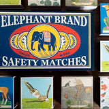 Collection of matchboxes with various designs and an Elephant Brand safety matches sign.