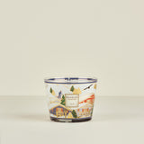 Decorative candle with a scenic design on a beige background