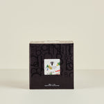 Black box with a smaller white card inside on a beige background