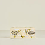 Box of Boodles collection with decorative designs on a beige background