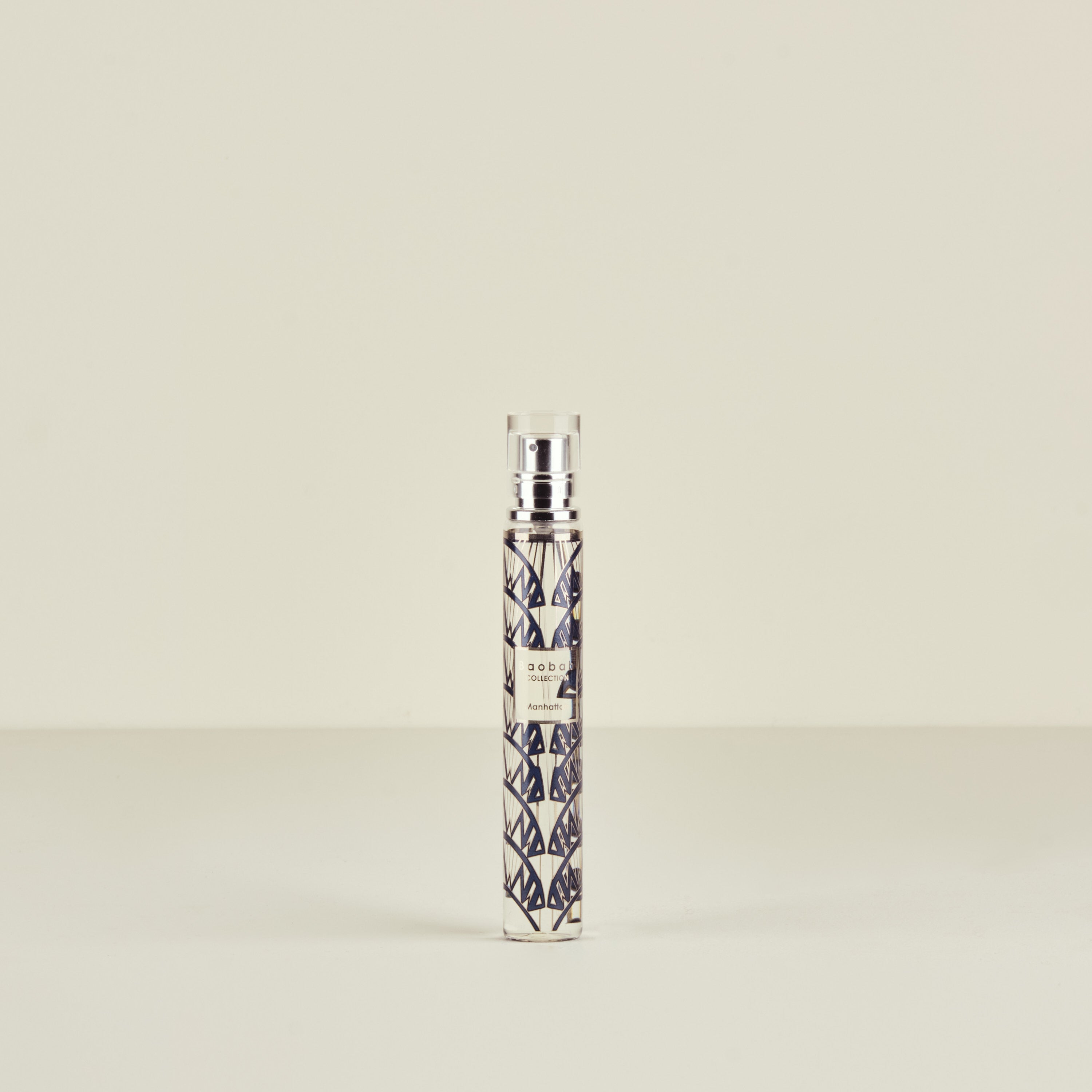 Perfume bottle with geometric pattern on a beige background