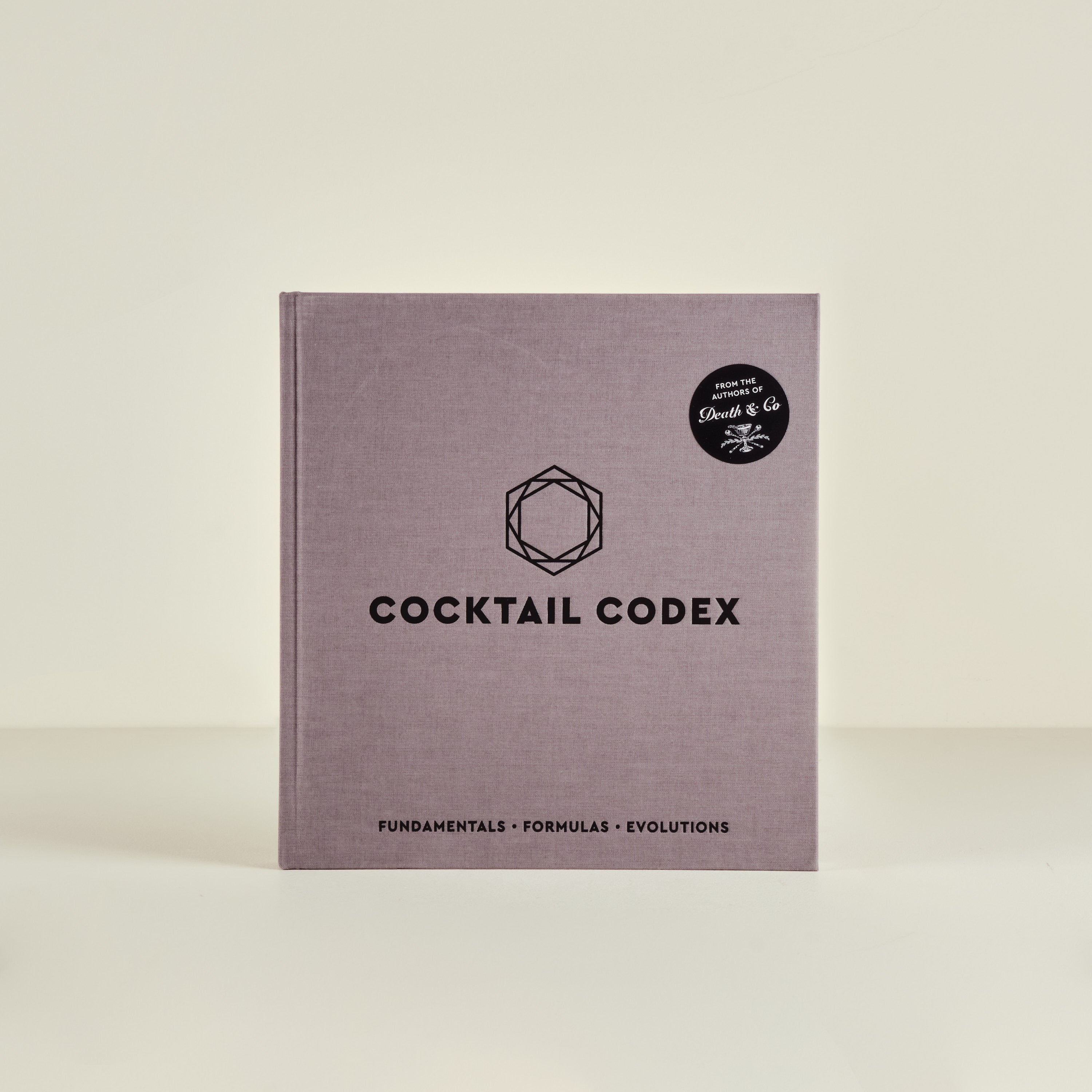 Cocktail Codex book with a logo on a beige background