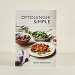 Cookbook titled 'Ottolenghi Simple' with images of food on a beige background