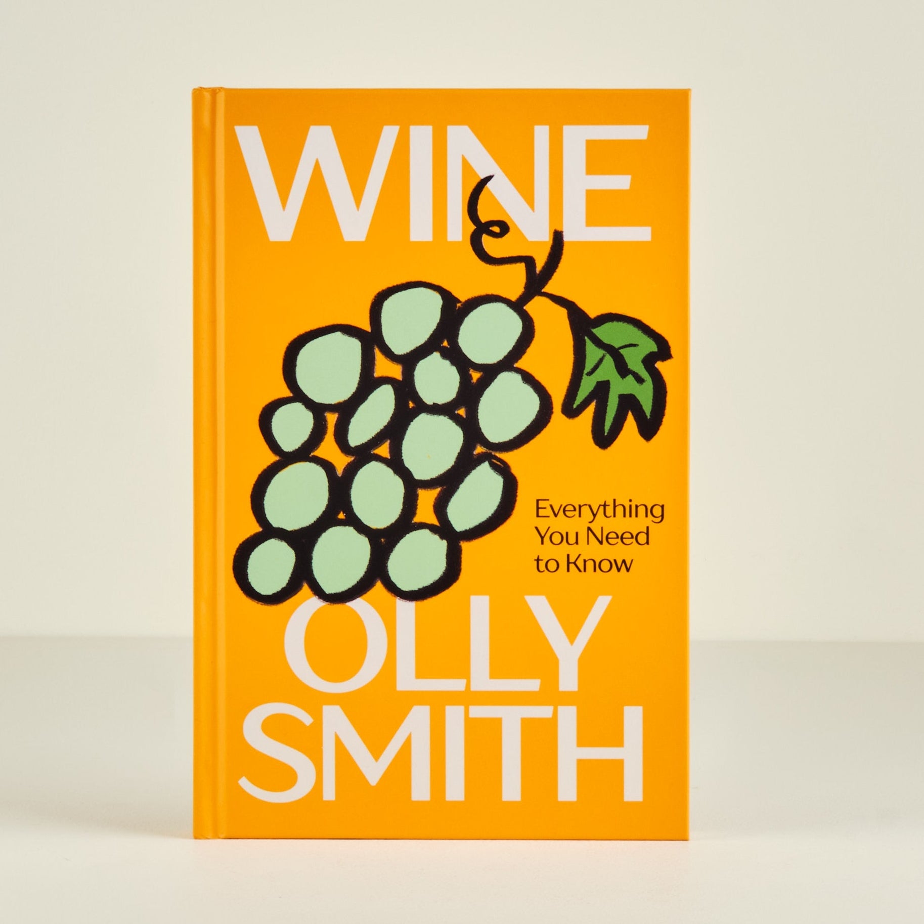 Book titled 'Wine: Everything You Need to Know' by Olly Smith on a beige background