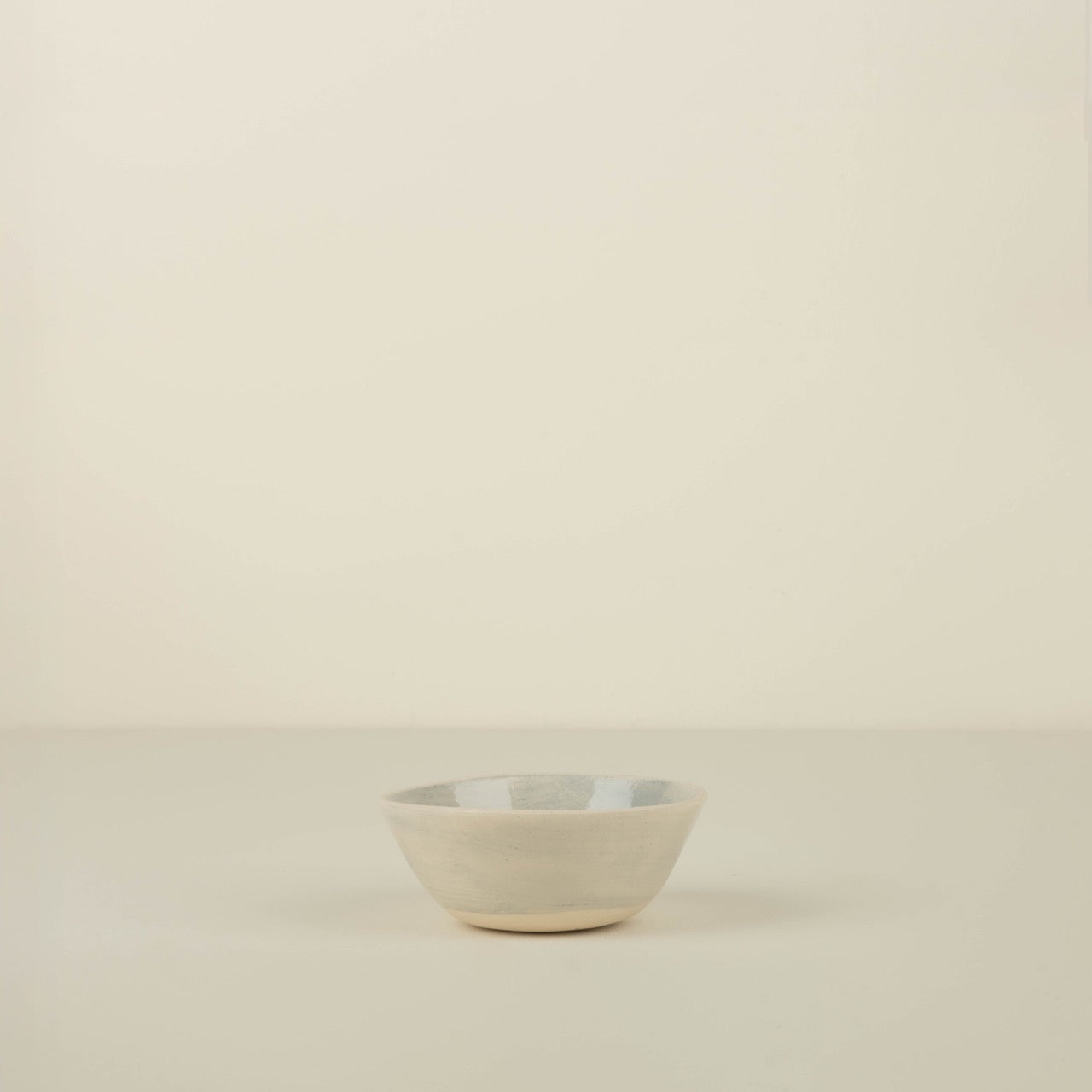 Small ceramic bowl on a beige background