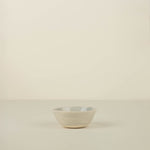 Small ceramic bowl on a beige background