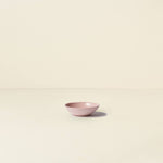 Pink ceramic bowl on a beige background