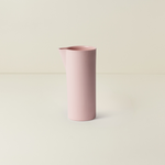 Pink cylindrical vase on a light beige background
