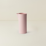 Pink cylindrical vase on a light beige background