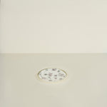 Decorative round plate with floral pattern on a beige background