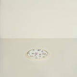 Decorative round plate with floral pattern on a beige background