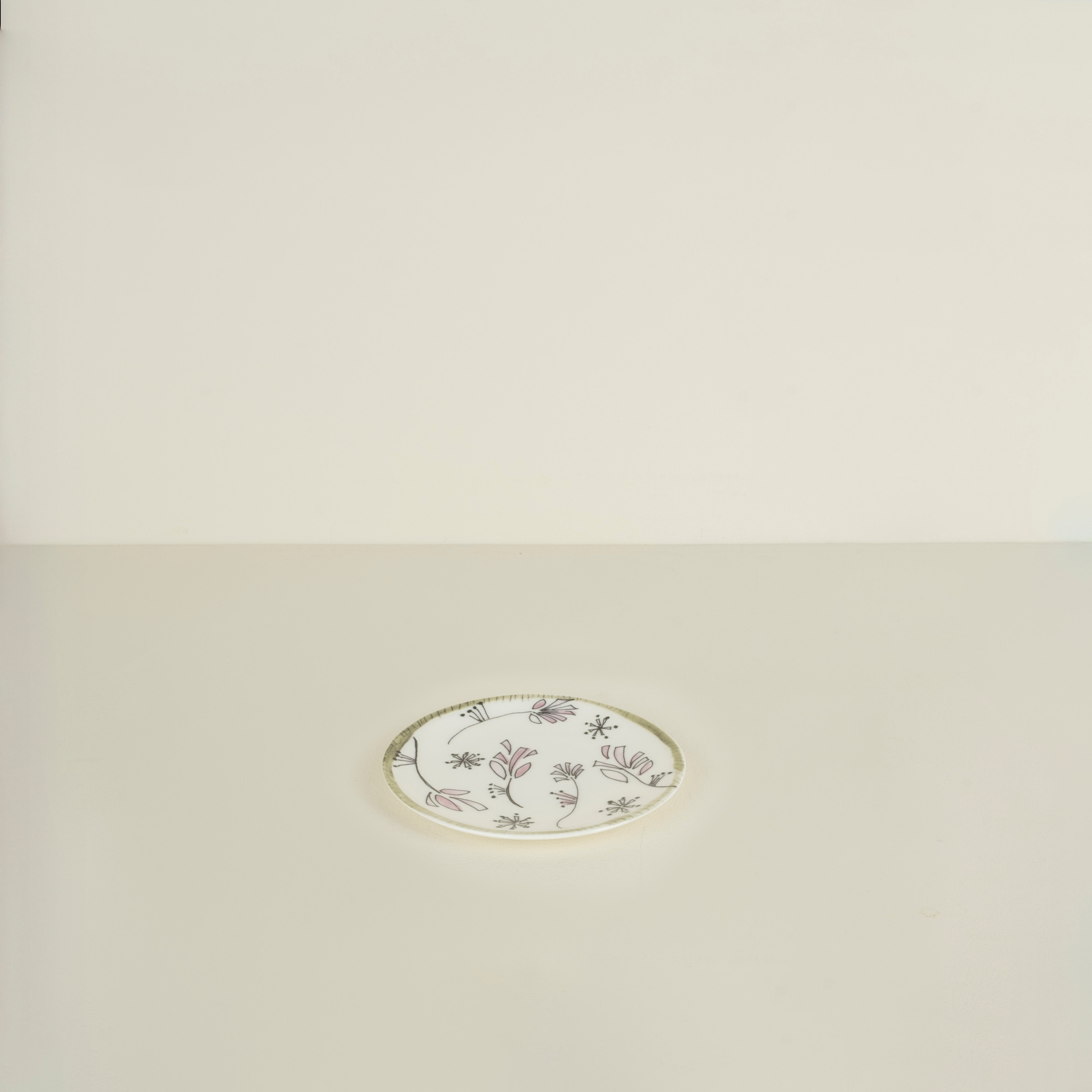 Decorative round plate with floral pattern on a beige background