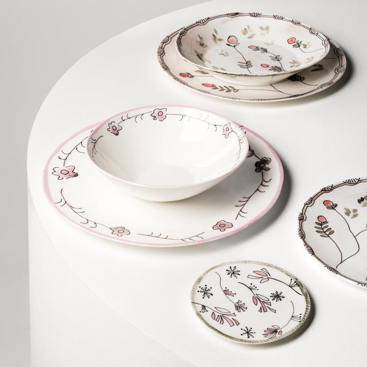 Set of ceramic dishes with floral patterns on a white surface