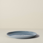 Blue ceramic plate on a beige background
