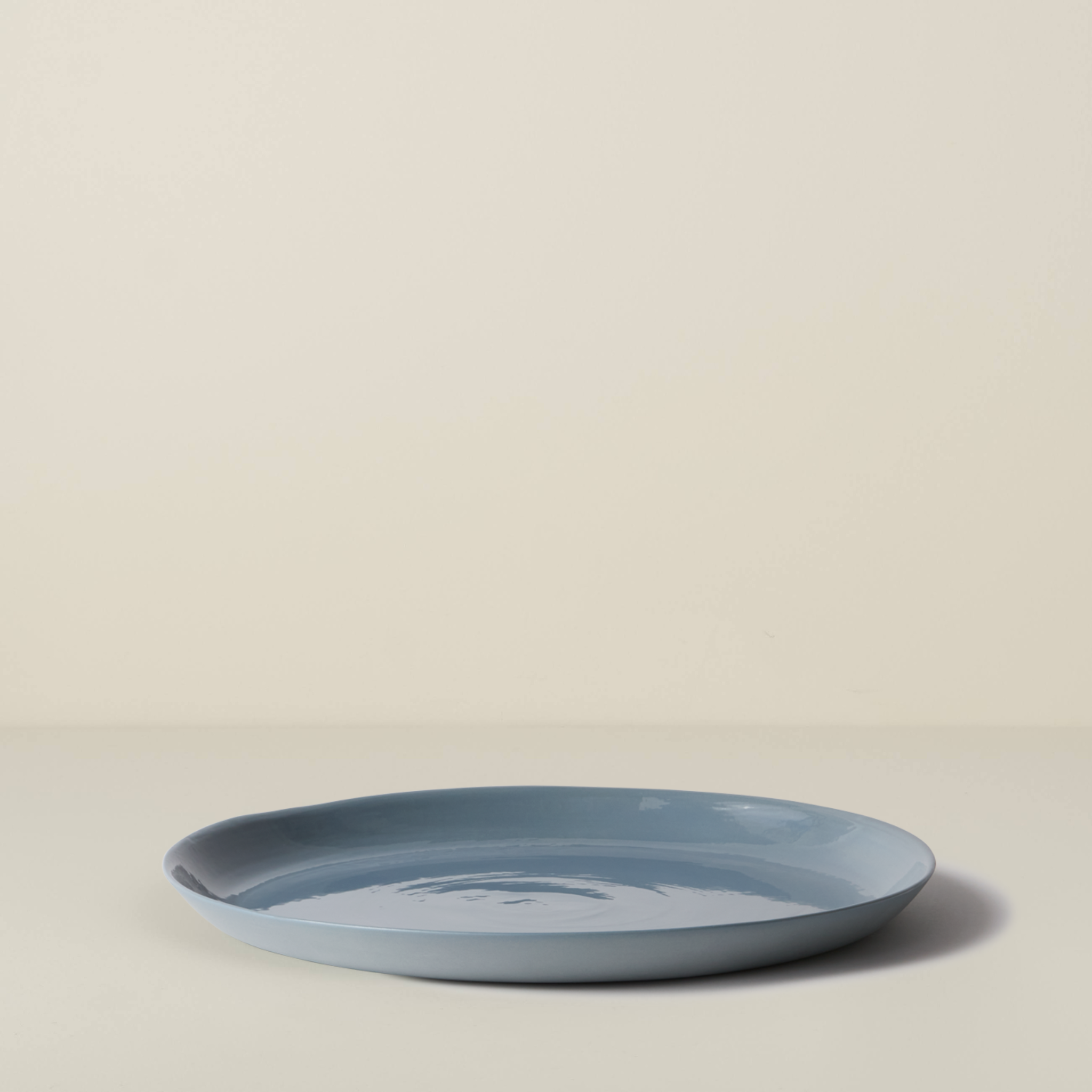 Blue ceramic plate on a beige background