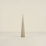 Tapered beige candle on a beige background
