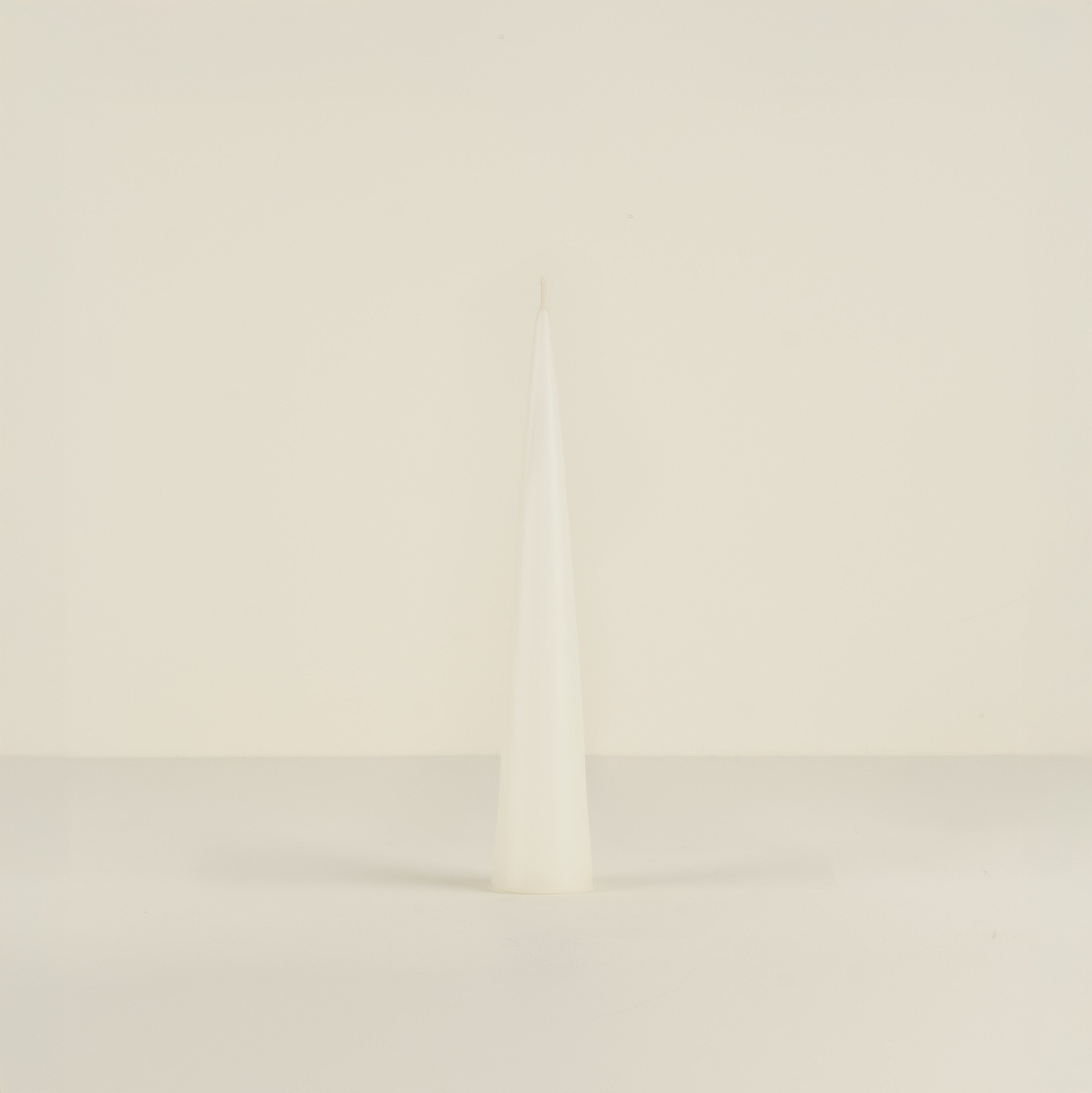 white candle object on a beige background
