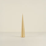 Gold candle on a beige background