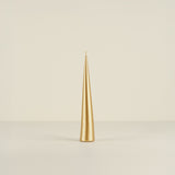 Gold candle on a beige background