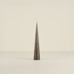 Tapered green candle on a beige background