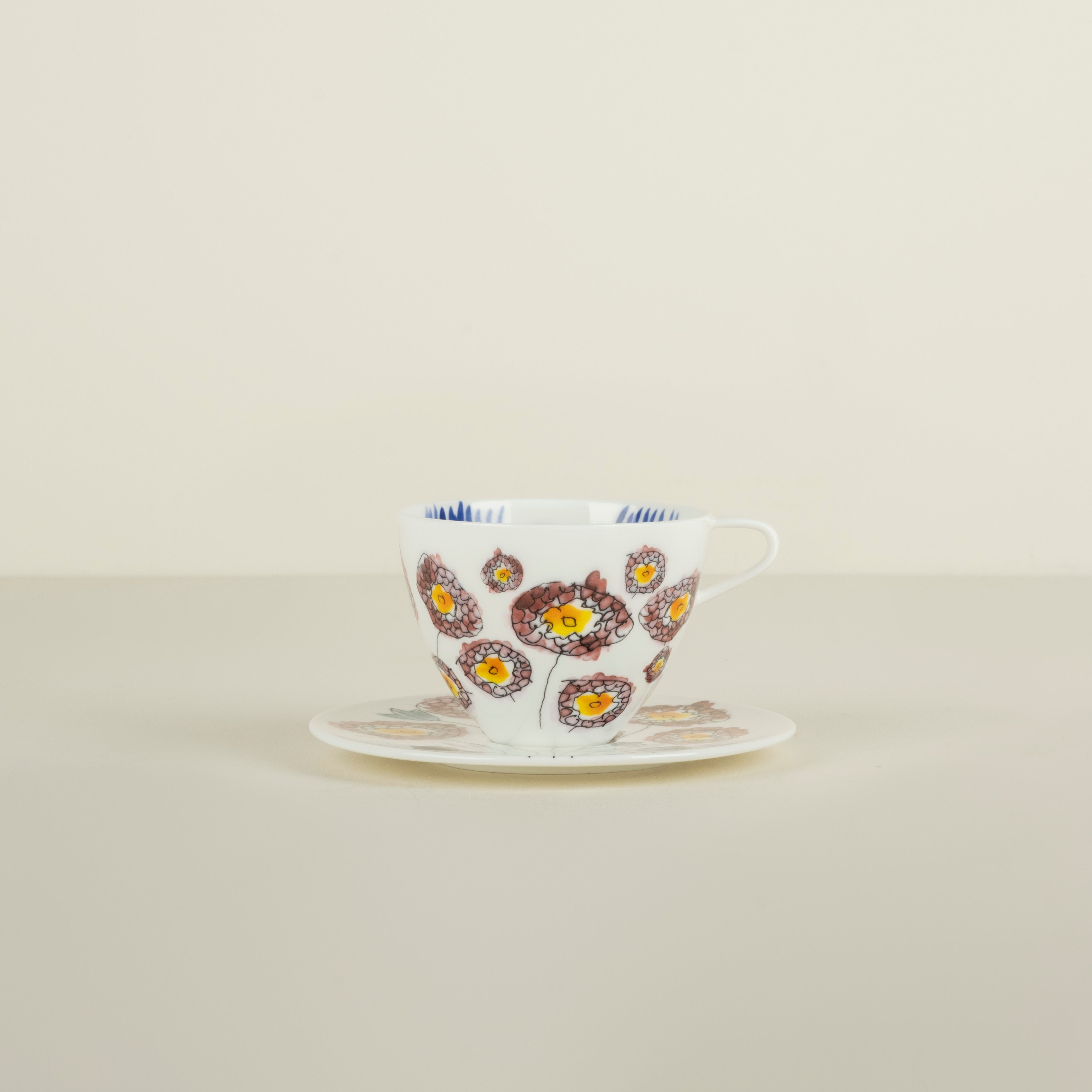 Teacup with floral design on a beige background