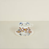 Floral teacup and saucer on a light beige background