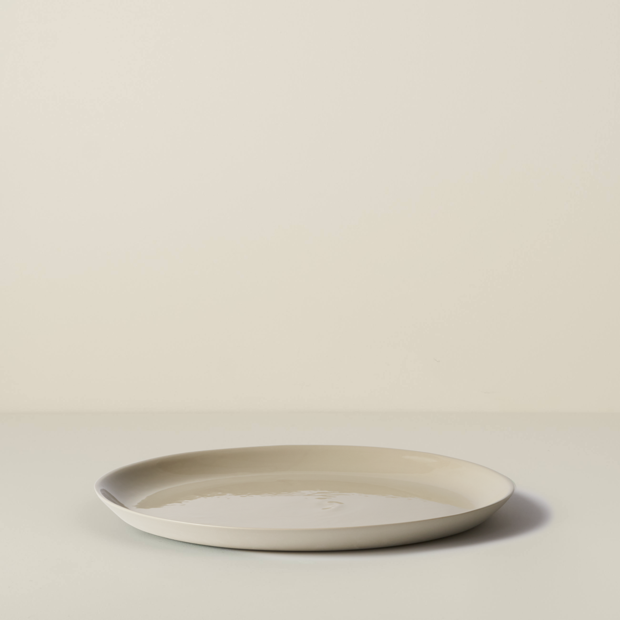 Beige ceramic plate on a beige background