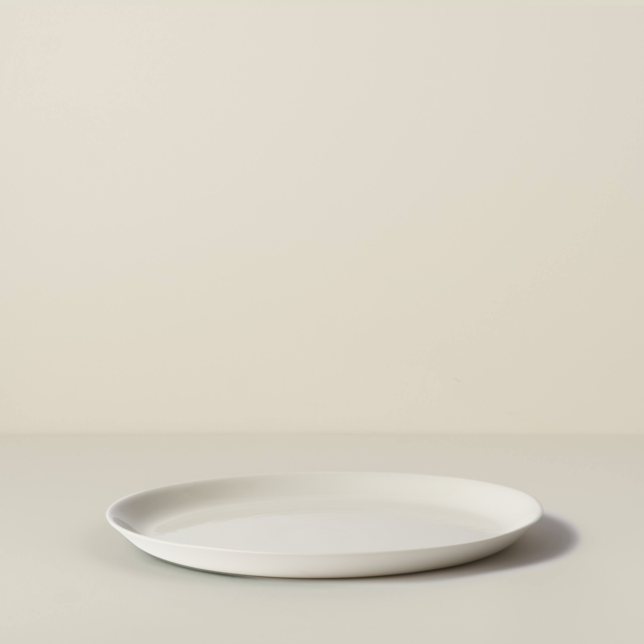 White ceramic plate on a beige background
