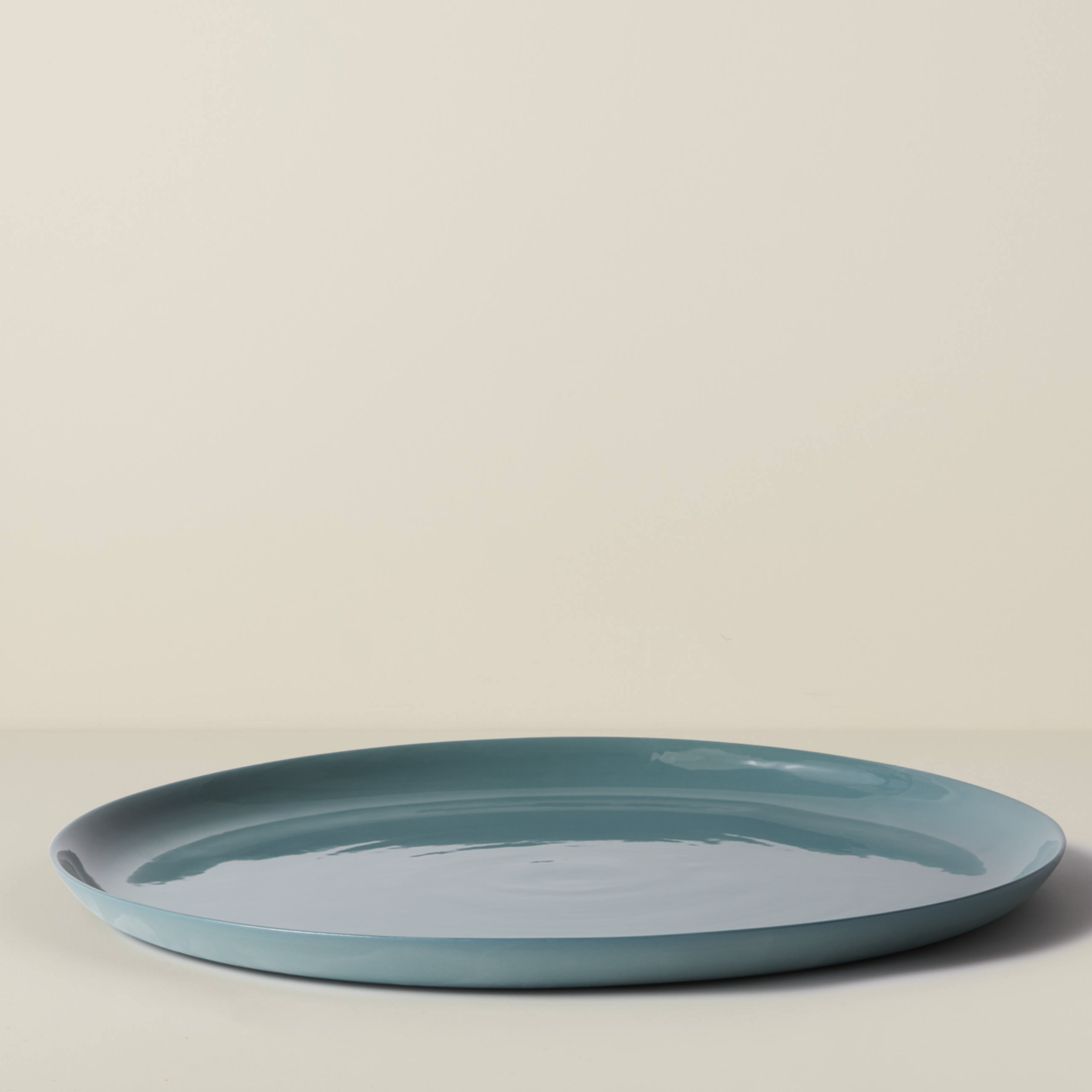 Blue ceramic plate on a beige background