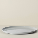 Light gray ceramic plate on a beige background