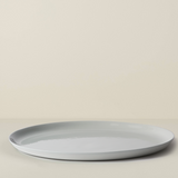 Light gray ceramic plate on a beige background