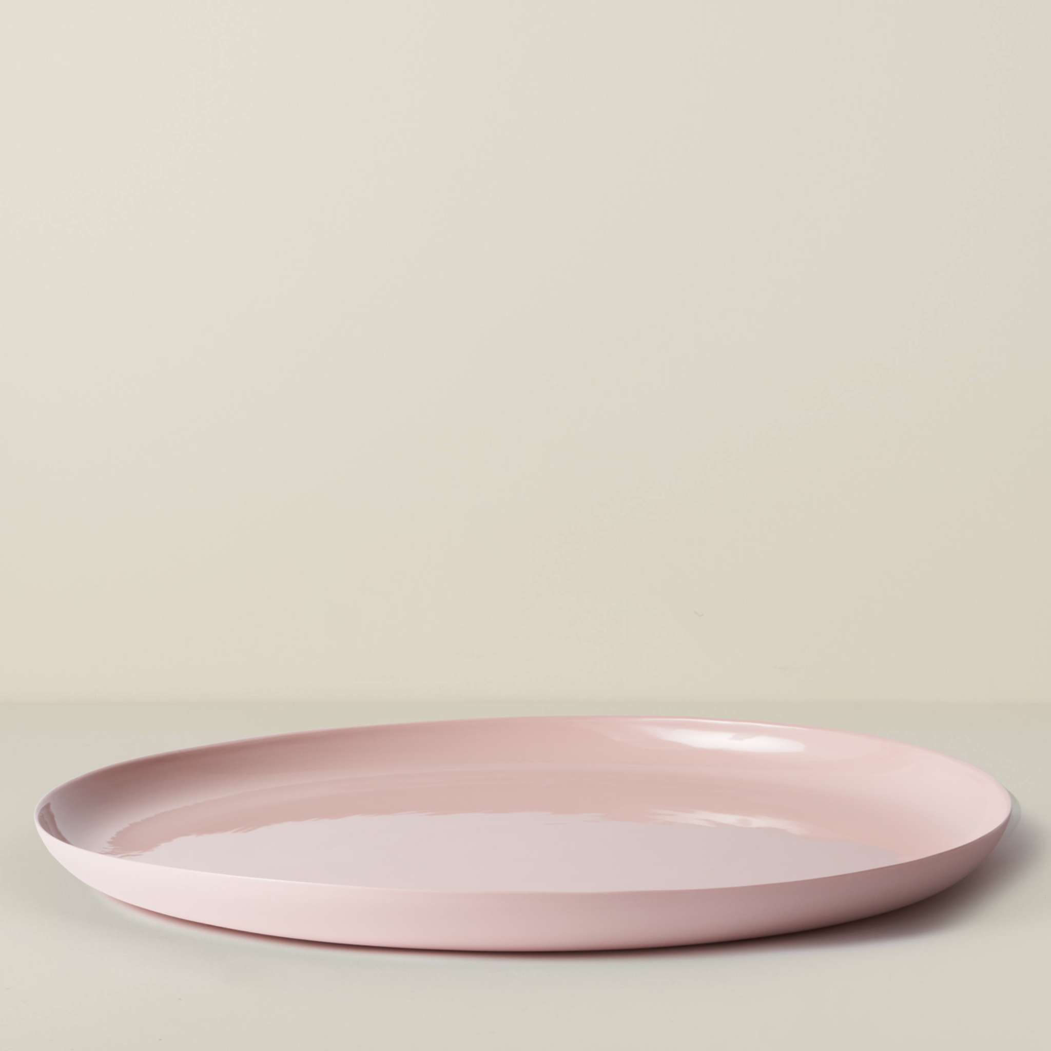 Pink ceramic plate on a light beige background