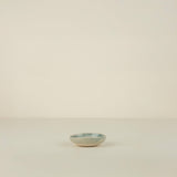 Small ceramic bowl on a beige background
