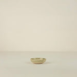 Small ceramic bowl on a beige background