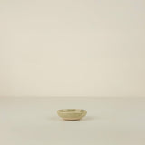 Small ceramic bowl on a beige background