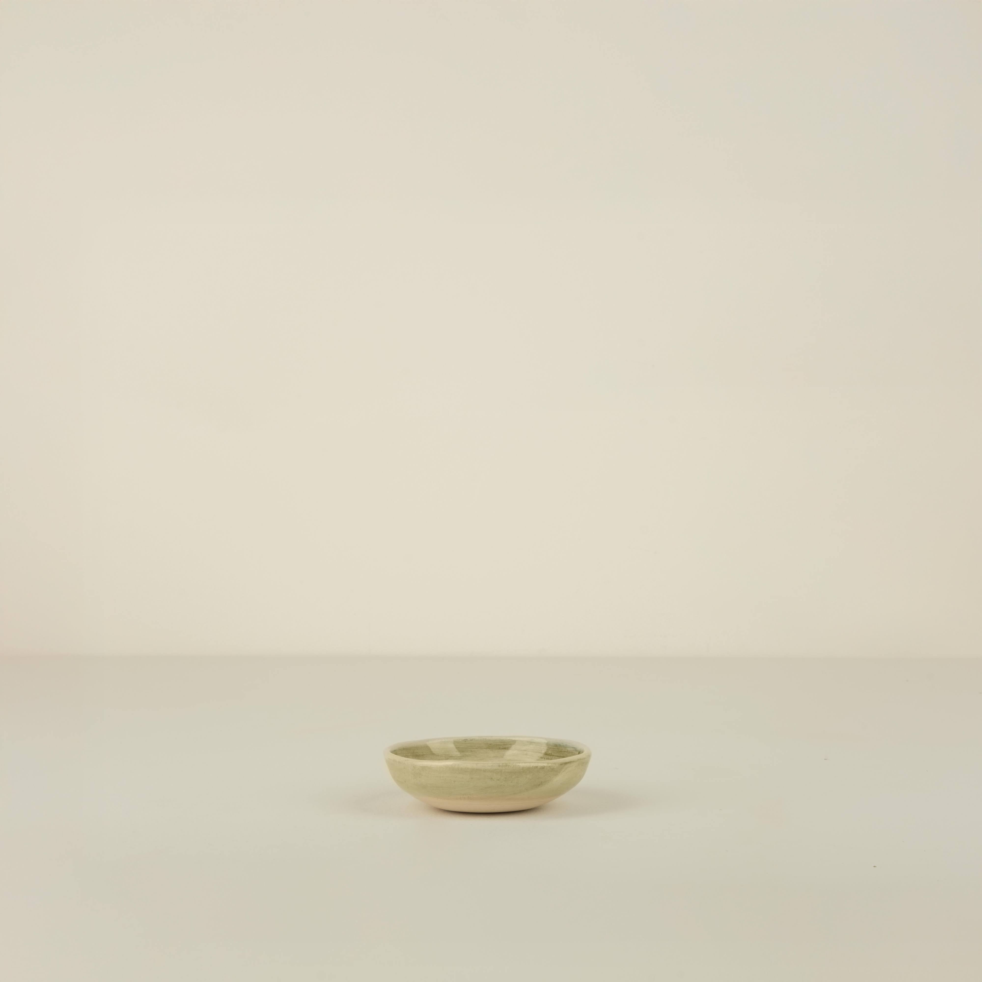 Small ceramic bowl on a beige background
