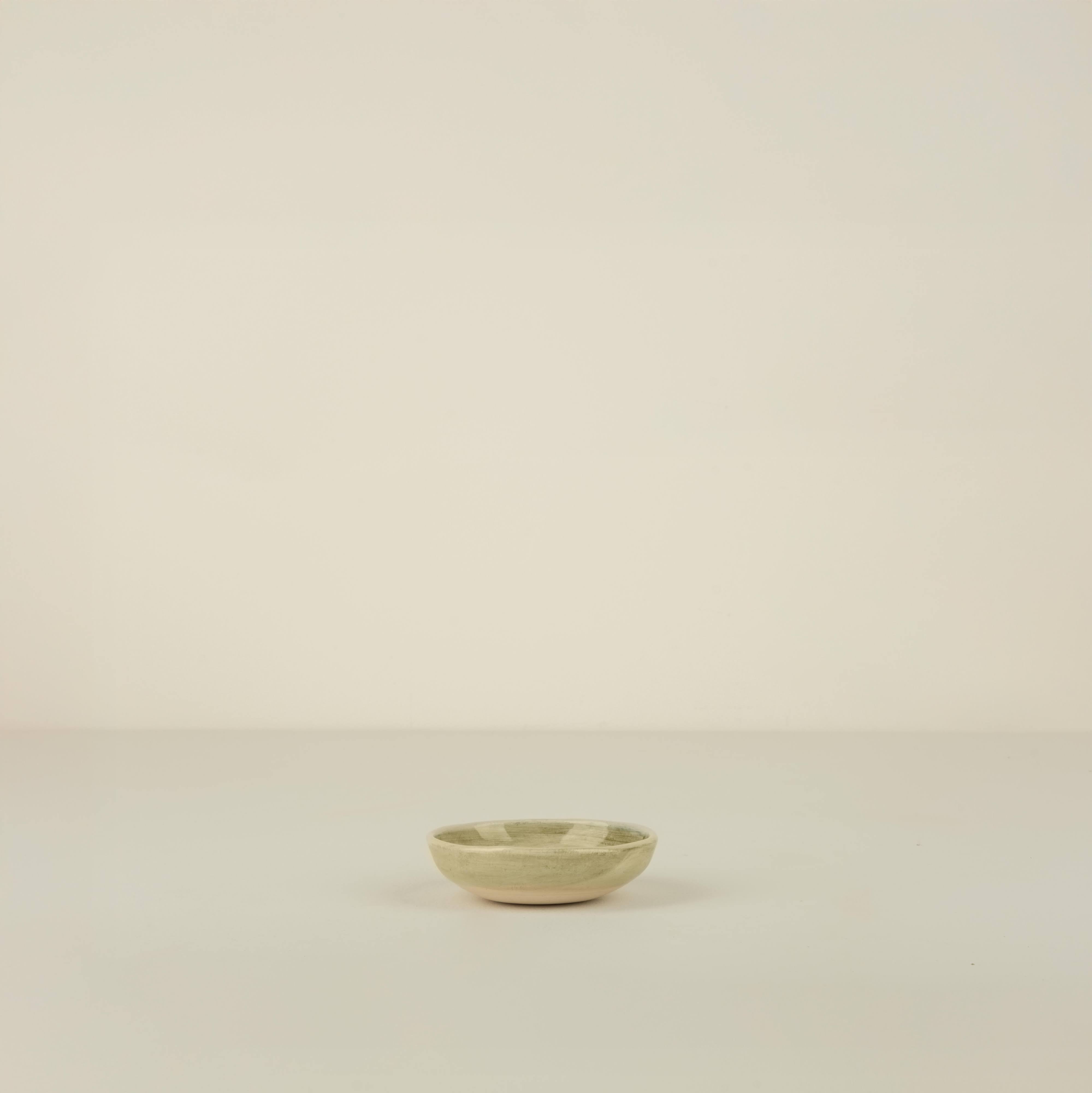 Small ceramic bowl on a beige background