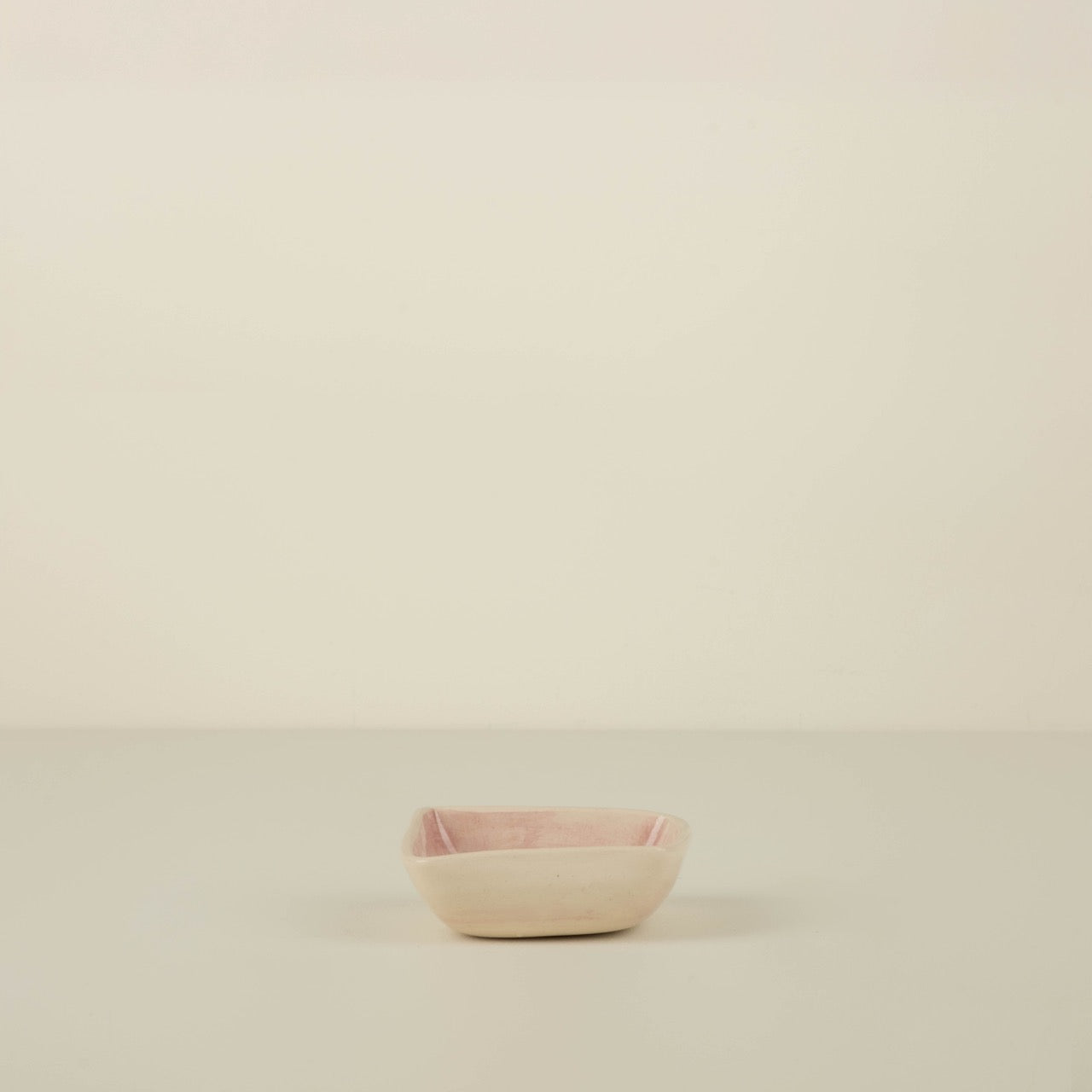 Small pink bowl on a beige background