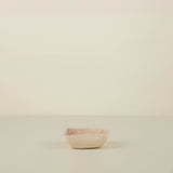 Small pink bowl on a beige background