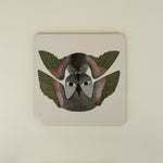 Square placemat with two bird design on a beige background