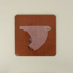 square placemat with owl on orange red background