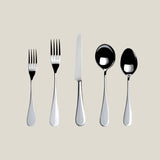 Set of silver cutlery including forks and spoons on a beige background