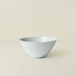 White ceramic bowl on a beige background
