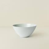 White ceramic bowl on a beige background