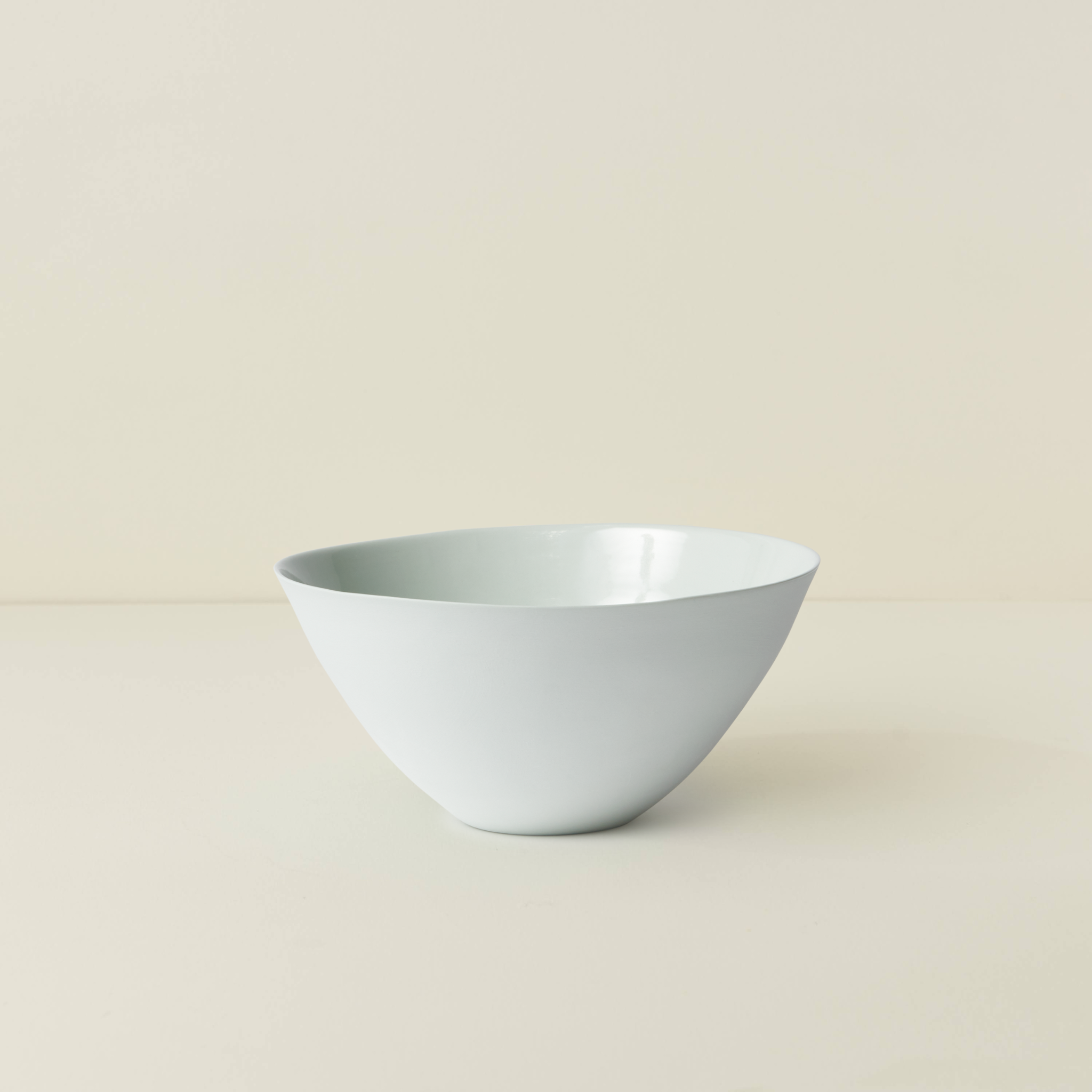 White ceramic bowl on a beige background