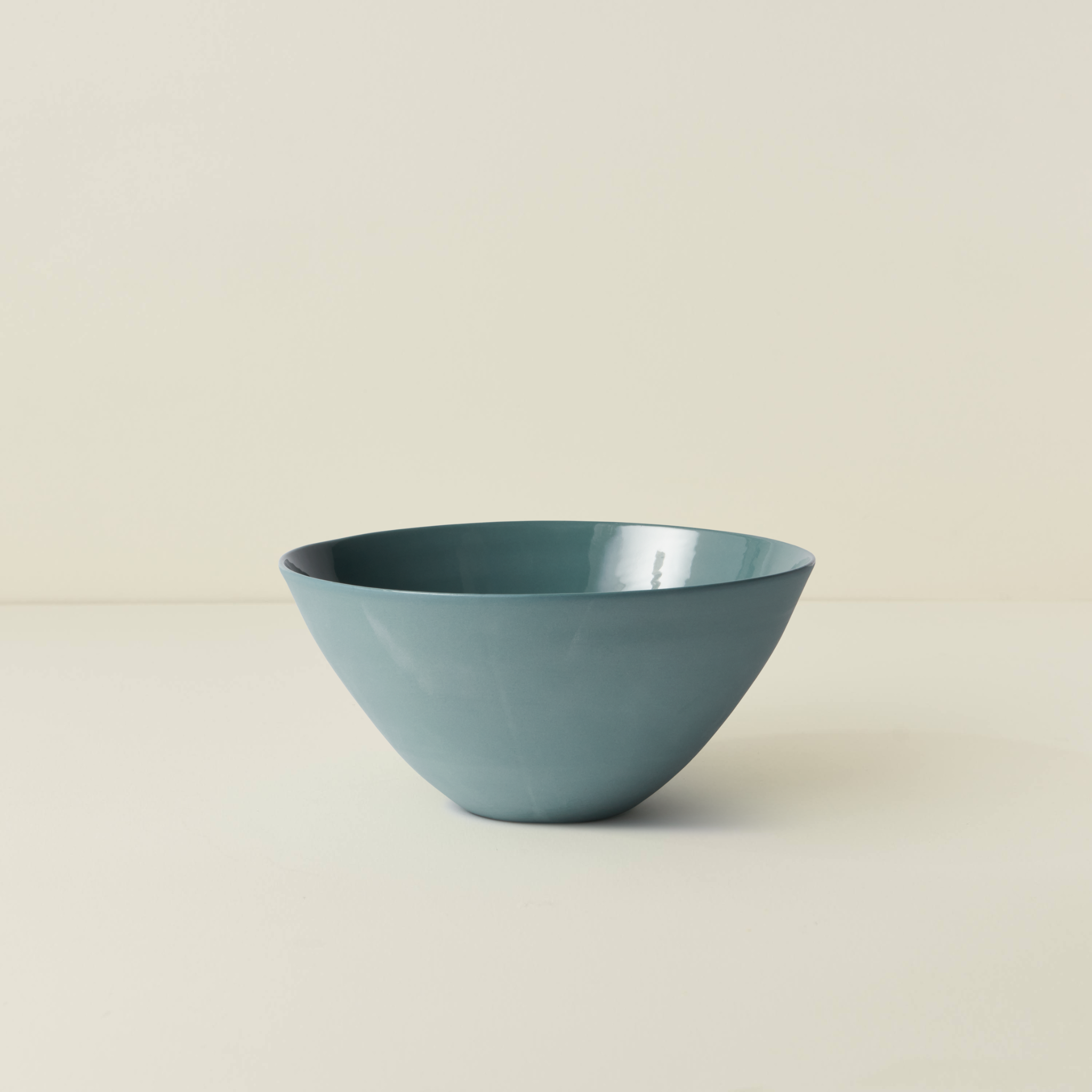 Blue ceramic bowl on a beige background